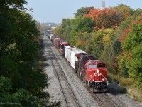 It's no secret that CP's Belleville Subdivision has gotten significantly quieter over the last decade or two. I tend not to visit it for that reason, but whenever I ride my bike down to the CN Kingston Subdivision, I'll inevitably cross the Belleville Sub at Cochrane Street here in Whitby. When I cross the bridge I'll check if the signals at either end of the siding are lit, which they rarely are, but on very rare occasion they will be! This was one of those times, I had just made it to the bridge and I noticed the signal at Whitby West was red indicating a train was occupying the track just beyond it. I waited a few moments, and before long I saw the headlights come around the bend. The train passed by at a particularly slow pace, eventually stopping somewhere between the Whitby siding and the Oshawa siding before continuing on its way about 10 minutes later. Clean AC44 rebuild 8154 heavily contrasts with 9360, which I presume had recently been used in coal service. A few cars back, there's a dimensional load in the form of one Bombardier Flexity streetcar.
<br>
<br>
This was the same week as some particularly bad wildfires on the west coast. The smoke had made its way here in the upper atmosphere, creating a haze in the sky and somewhat muting the brightness of the sun. This is easily my favourite weather conditions for photography, as it maintains the light while reducing any harsh reflections from glass or metallic surfaces. All the while, the colours of the trees were starting to noticeably change in some areas which significantly brightened the colour palette of the landscape. A very unique day to be out with my camera, that's for sure!