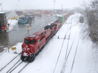 CP 112 is pushing a final cut of cars into Lachine IMS Yard on a snowy morning. Soon it will grab its mid-train DPU, then non-intermodal cars and its rear DPU before heading to St-Luc Yard.