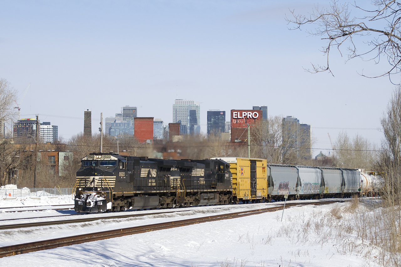 A pair of NS Dash9's (NS 9920 & NS 9646) lead a late CN 529 past the skyline of downtown Montreal. The track in the immediate foreground is the Turcot Holding Spur.