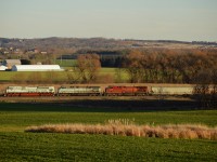 CP 113 approaches a waiting 420 in the siding at Baxter with a colorful consist of CP 7022 (Navy "Shipside Grey" scheme), CEFX 1002 (sporting CMQ paint), and CP 9729 (wearing nothing special) on the head end.