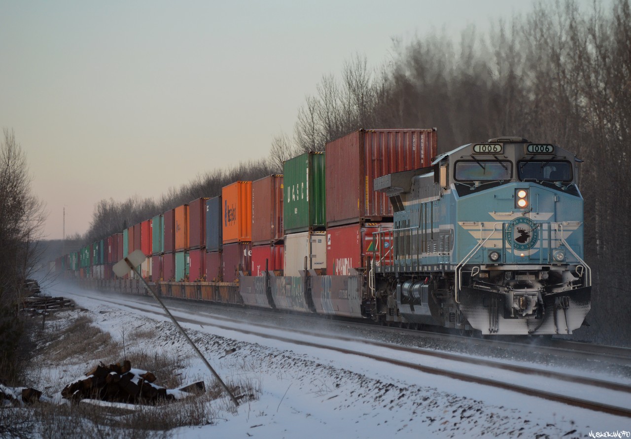 CEFX (CMQ) 1006 swirls up some snow at the rear of 113's freight with the road to themselves into MacTier.