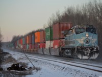 CEFX (CMQ) 1006 swirls up some snow at the rear of 113's freight with the road to themselves into MacTier.