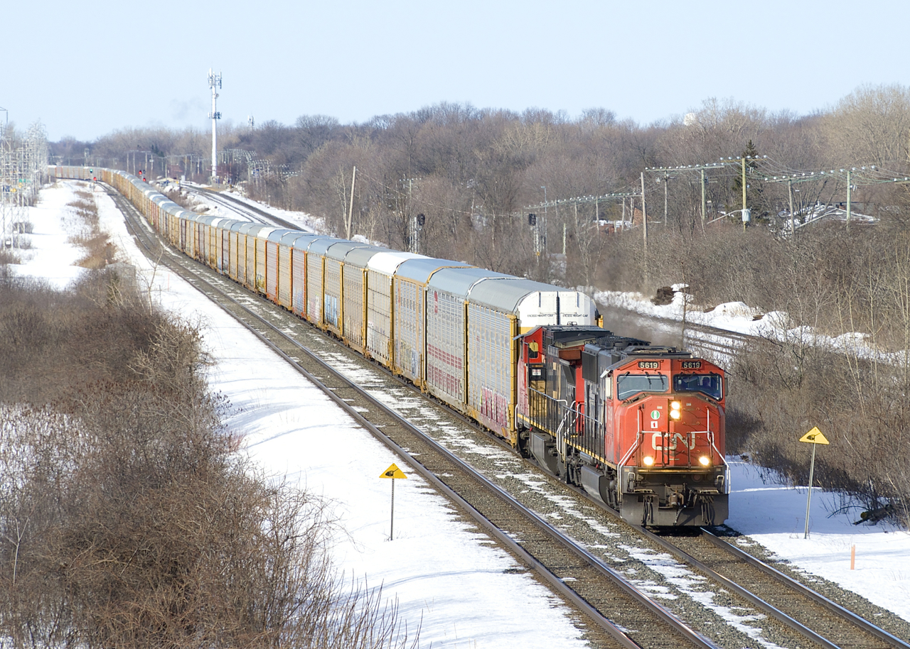 CN X322 has a train of solid autoracks as it passes through Beaconsfield with CN 5619 & CN 2183 for power.