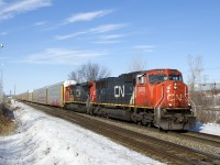 After a slight delay to allow CN 305 to cross from the north to the south track, CN X322 is on the move again, nearly at its destination of Taschereau Yard. Power is CN 5619 & CN 2183.