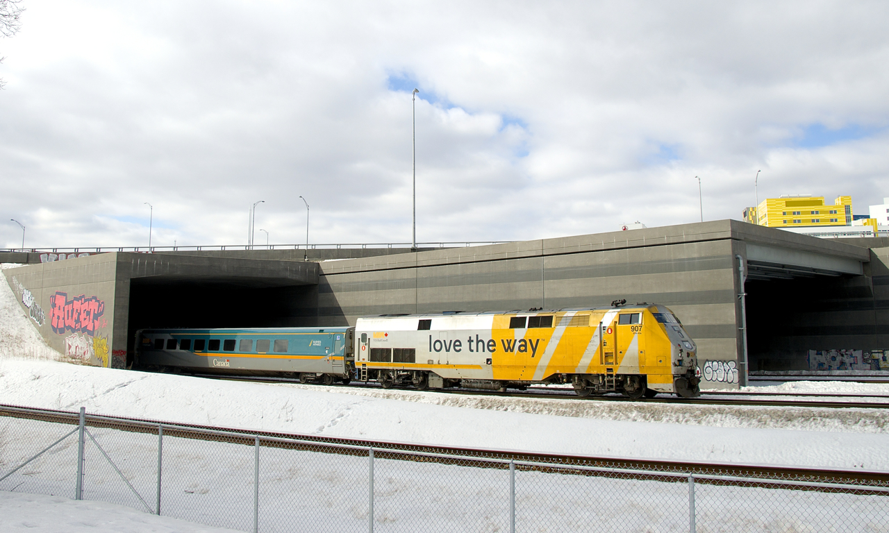 VIA 35 is mostly underneath the Turcot interchange as VIA 907 brings up its rear end. The tunnel it is passing through contains the south and north track of CN's Montreal Sub. The second tunnel behind it contains the freight track and track 29. In the foreground is the Turcot Holding Spur.