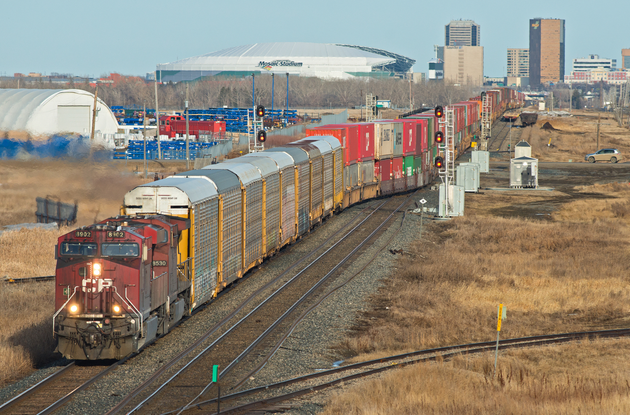 There is plenty to look at in this scene beyond the grungy pair of toasters on CP 113.  Above and to the right of 113's power is BRTX 2009, a Brant geneset demonstrator locomotive. Above at to the right of it is Mosaic Stadium, home of the Saskatchewan Roughriders. To the right of that is the skyline of down town Regina, Saskatchewan's capital city.