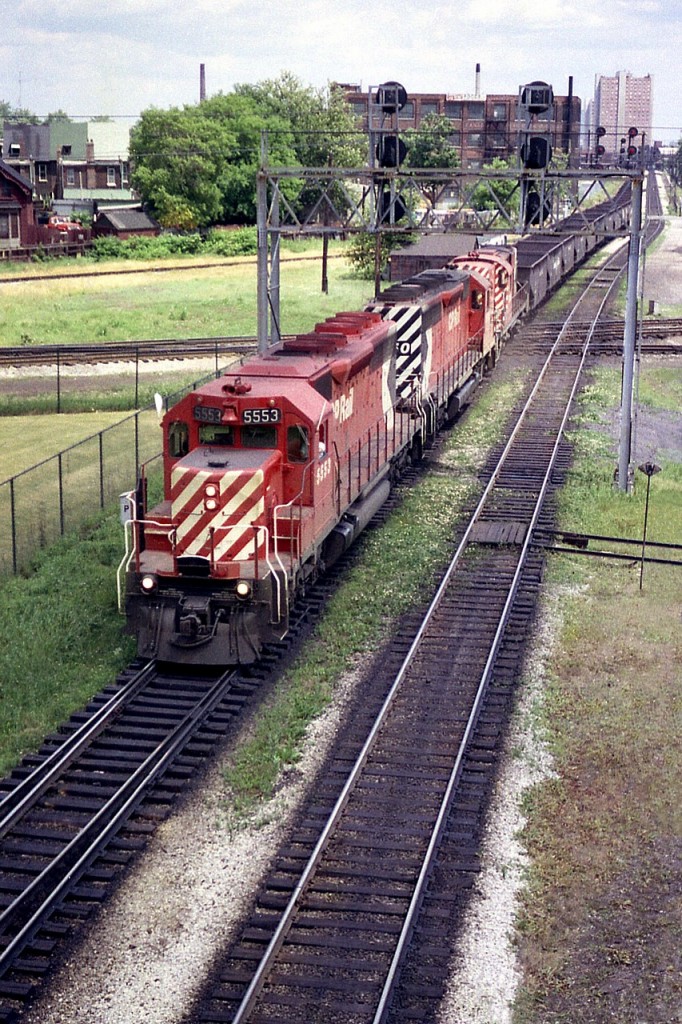 Rolling westbound across the old diamond at West Toronto Junction is an empty hopper train powered by CP 5553, 5550 and 8751.
This whole area has completely changed since the days us fans enjoyed watching and of course listening to trains in all four directions pounding their way over the diamond. I'm not sure you can even get near it now, having not been in the area for many years.
