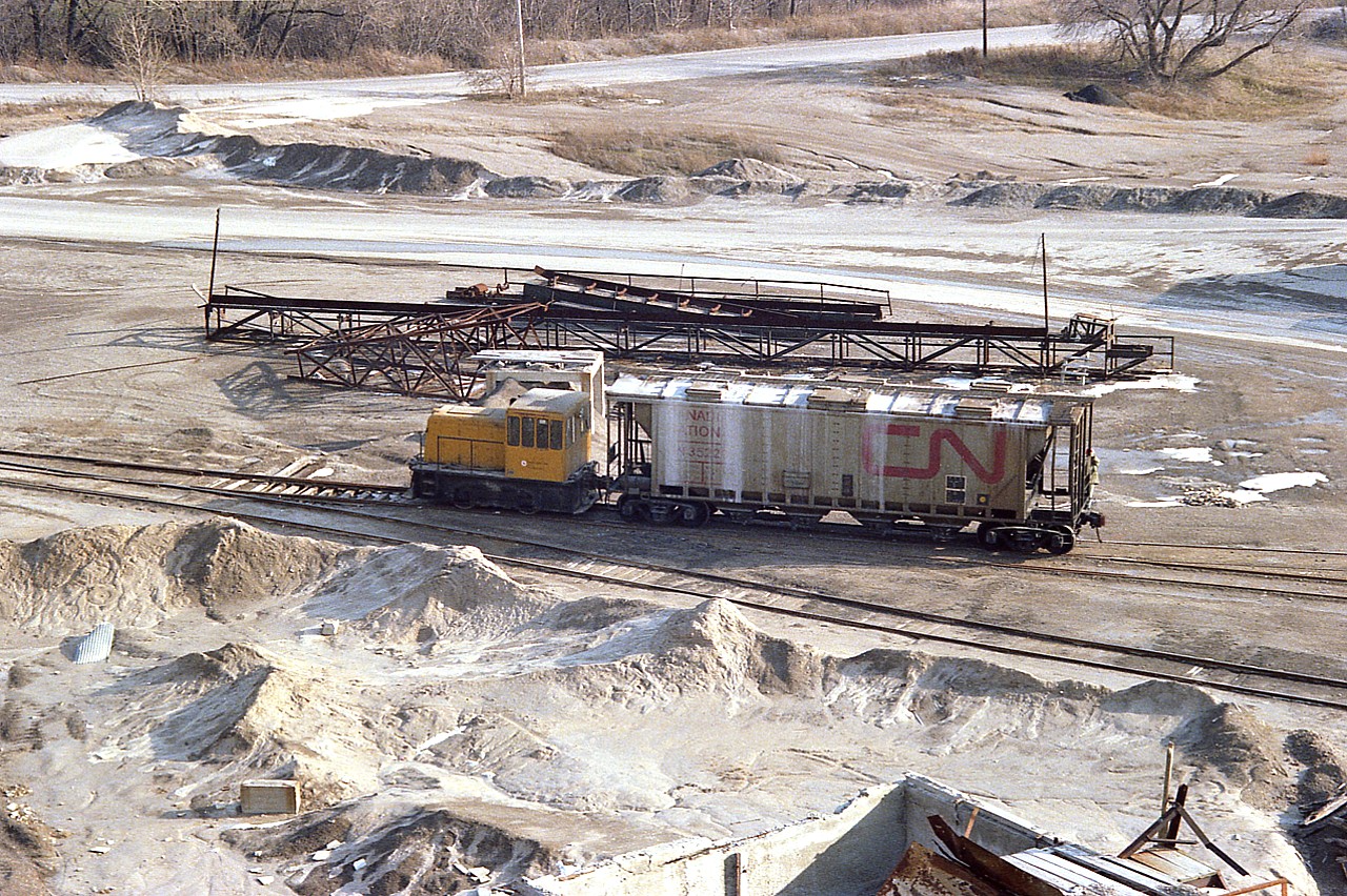 Below the escarpment at Dundas, and below where the Canada Crushed Stone operated, there was below the CN mainline an outfit called Dolomite Refractories Ltd, which operated until 1977 and was taken over by Steetley. The land is now occupied by a moderately upscale housing development. Here is an image of the switcher at work, as seen from the former CCSL conveyor overhang.
For details of this operation see  http://www.railpictures.ca/?attachment_id=25212