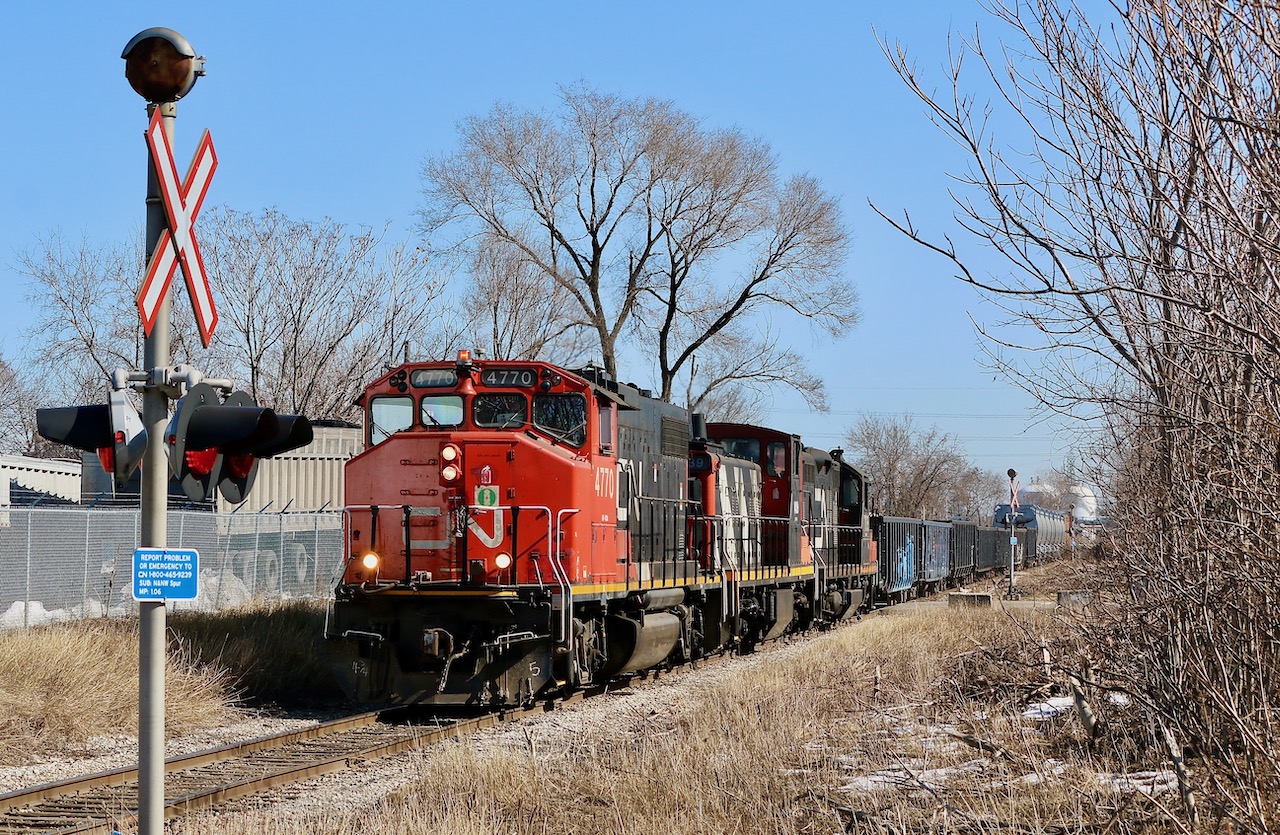 A decent mix of motive power adds some colour to the dormant scene as a CN local makes its way along the old N&NW spur on the way back to Hamilton yard after spending the morning deep in Hamilton's industrial core.