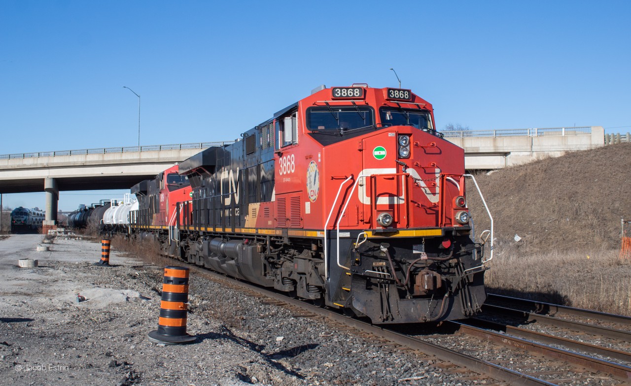 CN M386 sits tied down at Hal-West just West of the Bramalea GO station platform.