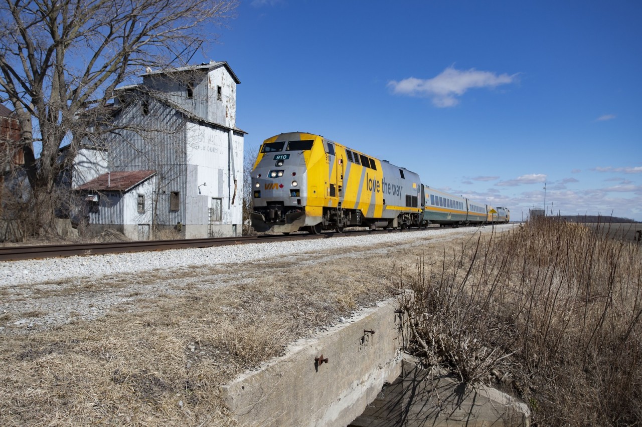 VIA 71 flies past the abandoned elevator at Prairie Siding. This is one of the only grain elevators of this style left in this area. I saw a photo by Bruce Mercer of an NS manifest passing this location in 1987 and I tried to recreate his frame here. Since then, the Chatham Sub has been single tracked in most places, the original Prairie Siding sign has been removed with a defect detector in its place, and the elevator is obviously no longer used. I'd like to submit this for the Time Machine. Here's the link to Bruce's photo

http://www.railpictures.ca/upload/knowing-that-sooner-rather-than-later-we-would-be-moving-from-chatham-to-brights-grove-and-ns-would-begin-using-the-new-chatham-east-connector-to-run-between-fargo-and-windsor-south-i-tried-to-sho