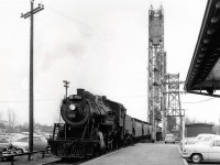 2663 heading west over the Welland Canal at the end of the steam era with a line of coal hoppers.  Destination unknown, but likely bound for the VALLEY CAMP COAL COMPANY, accessed via the Government Spur south of the Dunnville Sub main.  VALLEY CAMP's spur crossed King St. north of the Maple Leaf Mill and former Shell Re-fueling complex.  The photo has a clear view of the Lift Bridge and steam era Water Tower located on the east side of the canal.  Interesting to note that one of the semaphore arms (lower) has been removed, I am sure someone in the know can chime in on why it was reduced from three (3) to two (2) arms.  