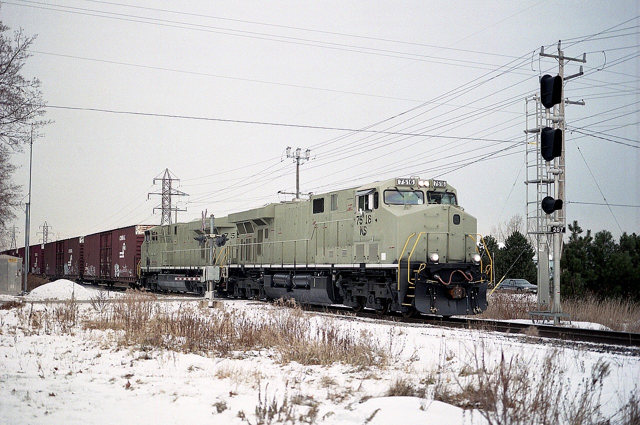 For awhile in the 2005 time frame, the NS was taking delivery of their new ES40DC locomotives faster than they could get them painted. The ones running around minus the NS black we referred to as "stealth".  Unusual to see two of them together, but here they are, NS 7516 and 7517 rolling thru Grimsby with train #328; Talbotville to Buffalo auto parts. The scene here is at Nelles Rd. Pretty soon these GEVOs seemed to be everywhere.