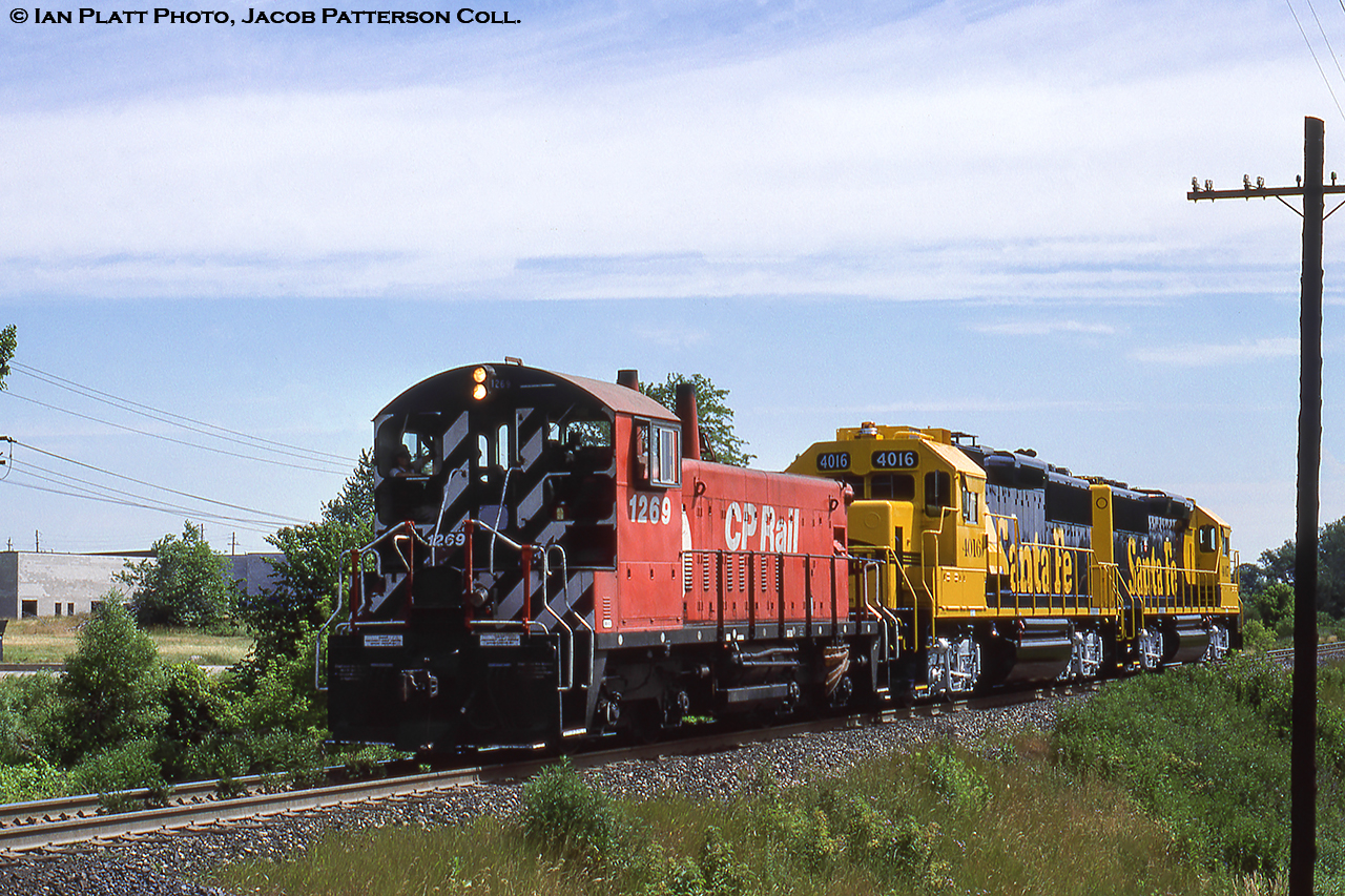CP pup 1269 is seen approaching the Clarke Road crossing after departing GMD London with new ATSF power in the form of 3800hp GP60s number 4016, 4017, part of a twenty unit order (4000 - 4019).  The 4016 would become BNSF 8716 in January 1998, renumbered to BNSF 175 around 2014, and was still active within the last year.  ATSF 4017, renumbered BNSF 8717 in October 1998, to BNSF 176 about 2014, and was still active within the last year.What happened to the 1269?  Originally the 8169, rebuilt to a slug in 1995 and renumbered to CP 1022 in 1996, retired 2012.Ian Platt Photo, Jacob Patterson Collection slide.