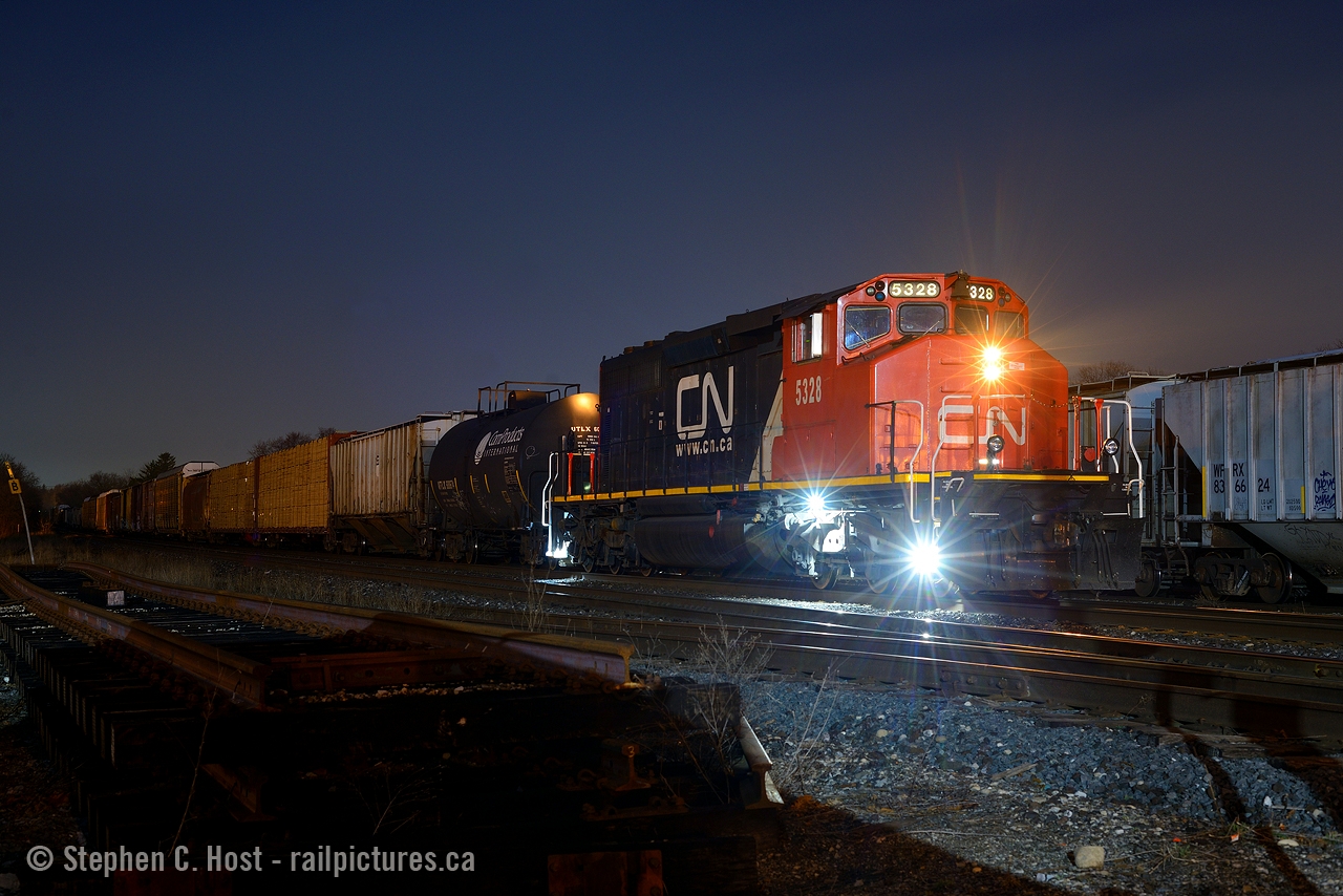 A solo CN SD40-2 on a mainline freight in 2021? Pinch me. With over 5000 foot of train, work at Beachville, Brantford and aldershot, there was no shortage of complaints from the crew about the 'Sarnia yard engine' assigned to the job, but the photographers didn't mind... thank goodness they had work at Brantford, sometimes you just never know. With the headlight streaming in the cool damp Brantford night, the conductor is walking the train to make the cut for a setoff and lift in the Brantford yard just after arriving. Photo notes, 50mm f/1.8 which gives the nice 'star' effect for night shots. Anyone here use a 'star filter' to get the same effect? Only my 50mm lens does this.