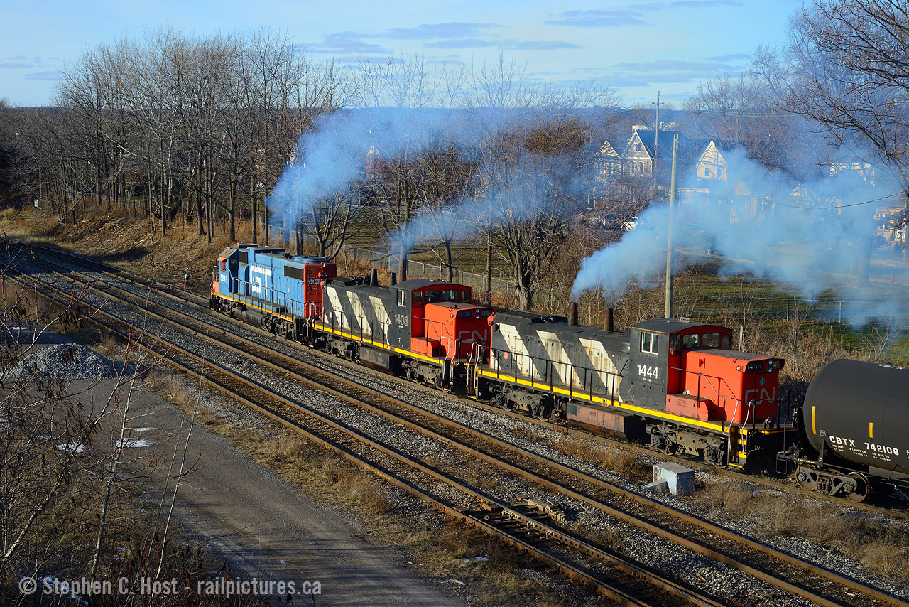 Working hard to pull their loaded Steel Coils from Stelco out of 'the hole' a trio of EMD locomotives are smoking good as they struggle to maintain speed on the westward grade. Nothing beats this sound... even if only for a minute..