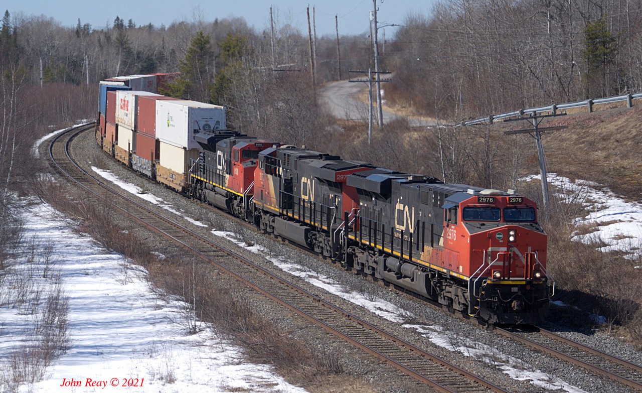 120 is climbing the hill from Amherst to Springhill Jct, Nova Scotia. 12:48 local time, March 22nd, 2021. Power is 2976, 2972, 8100. 552 axles. This train had no DPU. Springhill Jct is MP 59.5 on the CN Springhill sub, which runs from Moncton, NB to Truro, NS. The siding here is 11,350' long and is the former junction with the adandoned coal branch to Springhill (of mining disaster fame.)