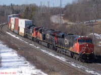 120 is climbing the hill from Amherst to Springhill Jct, Nova Scotia. 12:48 local time, March 22nd, 2021. Power is 2976, 2972, 8100. 552 axles. This train had no DPU. Springhill Jct is MP 59.5 on the CN Springhill sub, which runs from Moncton, NB to Truro, NS. The siding here is 11,350' long and is the former junction with the adandoned coal branch to Springhill (of mining disaster fame.)