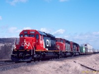 Westbound CN Laser train seen at Haskill Road, Hope Township (Port Hope, ON) on the Kingston sub in May 1996. Power is 5387, 5311 and 5022.