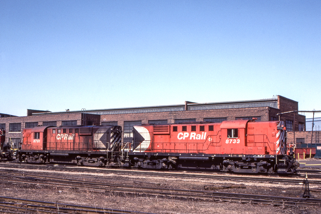 CP 8733 and CP 8791 are in Hamilton, Ontario on March 27, 1984.