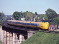 <br>
<br>
  Clean at the stack(s).... 
<br>
<br>
  A daily sight: Rolling over the Ganaraska River valley, VIA Rail #67 is Turbo equipped today. 
<br>
<br>
  At Port Hope, June 27, 1982 Kodachrome by S.Danko
<br>
<br>
  By October 31,1982: Turbo gone. 
<br>
<br>
  What's interesting:
<br>
<br>
 the TurboTrains, there were five TurboTrains built circa 1967 – 1968, and CN intended to operate 2 sets in tandem on each of two trains with the fifth set as a spare. 
<br>
<br>
  a collaboration between MLW and United Aircraft (United Technologies) were each Turbo set was built as seven semi permanent coupled cars: 5 coaches, 2 Turbo Power (coach) Cars: Turbo Power cars: #125 to #129 inclusive and #150 to #154 inclusive;
<br>
<br>
  The Turbo saga is a long story, to keep this brief: During a 1971 're-build' program CN decided to increase passenger capacity, breaking up two sets and adding two intermediate coaches to each of the three remaining intact sets. 
 <br>
<br>
  The remaining four Power Cars and four coaches were sold to Amtrak, however before delivery Turbo Power Cars 128 and 154 (Amtrak 54 & 55) were involved in a wreck that retired 54 (128) and 55 (153) was retained by CN as a spare. (per Trackside)
<br>
<br>
  Despite the reputation, after the 1973 reintroduction through to 1982 retirement, the three Turbo Train sets developed a 97% availability rating ( per Wikipedia)
<br>
<br>
  To date I have located only one image showing (one of the five) original whole seven car CN Turbo Train(s), making the image the rarest of rare ( for example more rare than images of CP Rail's one of a kind M-640 #4744): 
<br>
<br>
 <a href="http://www.railpictures.ca/?attachment_id= 26663"> an original </a>
<br>
<br>
 <a href="http://www.railpictures.ca/?attachment_id= 12276"> the only M-640 </a>
<br>
<br>
  sdfourty
