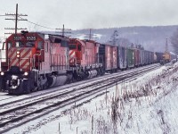 <br>
<br>
  White Flags flapping, a ubiquitous SD40 assists M-636 #4735 on the grade up to Guelph Junction
<br>
<br>
  The local CP Rail Foreman occupies the south track with a Burro crane, flat and caboose
<br>
<br>
  Extra 5528 west, on the approach to Guelph Junction, January 18, 1981 Kodachrome by S.Danko
<br>
<br>
  more Campbellville action:
<br>
<br>
 <a href="http://www.railpictures.ca/?attachment_id=  8760">   push service    </a>
<br>
<br>
