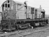 <br>
<br>
   So, when is locomotive, no longer a locomotive ?
<br>
<br>
   Traction motor platform....rather... frame with traction motored trucks …a k a.....a calf ?
<br>
<br>
    Perhaps let's start over....
<br>
<br>
   Carrying AAR Reporting Mark   XALX  , an ALCO S,  former R&S #101 and perhaps former  A&JR#101 * is sans prime mover, radiators and more, rests outside the fence at Andrew Merrilees Ltd
<br>
<br>
   Anyone know if  XMLX  former  R&S#101 did return to service  ?  and survived  to 1990  ?
<br>
<br>
   at West Toronto, December 22, 1979  Kodak Tri X negative by S.Danko
<br>
<br>
    *  Alma and Jonquieres Railway, owned by Alcan, merged into Roberval and Saguenay Railway on  January 1 , 1974 
