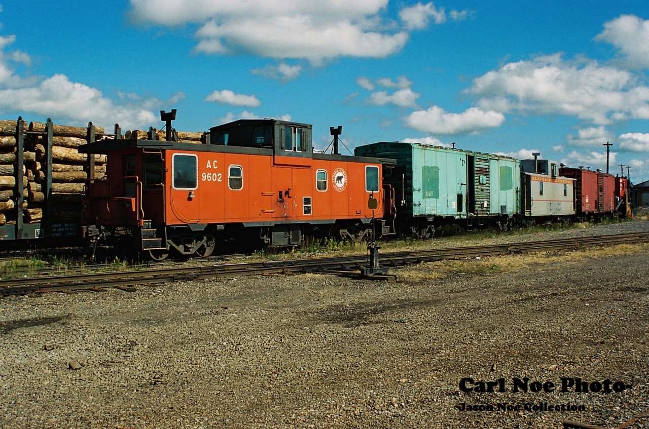Former Algoma Central Railway caboose 9602 and several other pieces are seen at Wisconsin Central's Sault Ste. Marie yard in September 1995.