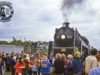 The people are everywhere at Guelph station on September 21, 1975 which saw CNR U-1-f “Bullet Nosed Betty” 6060 leading an excursion chartered by the Buffalo Chapter of the National Railway Historical Society from Niagara Falls to Guelph via Lynden on the Fergus Sub.  The 4-8-2 Mountain type locomotive, built in 1944 by the Montreal Locomotive Works, is seen posed alongside CNR 4-8-4 Confederation type 6167, which was retired from these same excursion duties 11 years prior.  Today CNR 6167 can still be found in downtown Guelph, <a href=http://www.railpictures.ca/?attachment_id=43392>recently relocated to its third home</a> in Priory Park.  CNR 6060 is now under restoration by the Rocky Mountain Rail Society in Stettler, Alberta.<br><br>More from this day:<br><a href=http://www.railpictures.ca/?attachment_id=44599>Nortbound at Harrisburg</a> by Bryce Lee.<br><a href=http://www.railpictures.ca/?attachment_id=42990>Photo runby near Guelph</a> by Bruce Lowe.<br><a href=http://www.railpictures.ca/?attachment_id=14342>At CN Guelph Junction</a> by Bill Thomson.