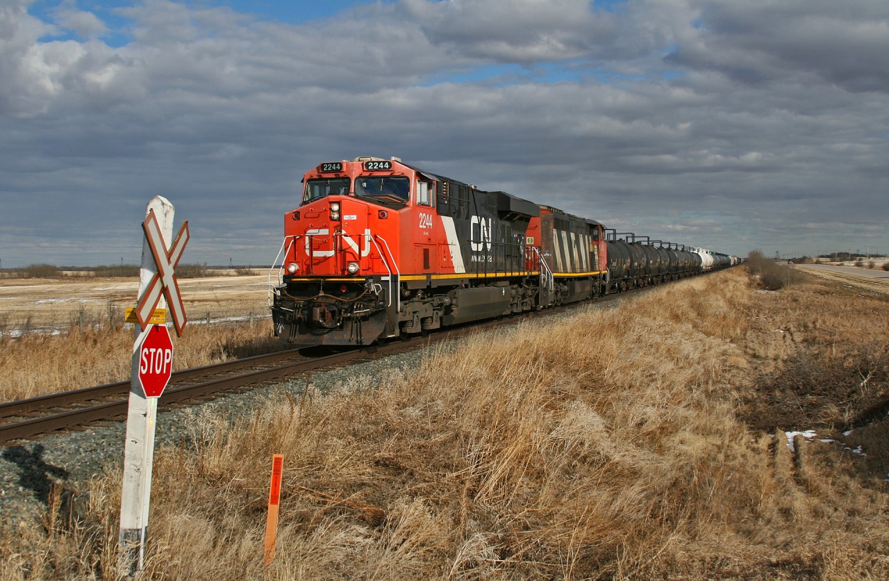 CN M 31341 11 highballs across the Prairies on a beautiful spring afternoon.