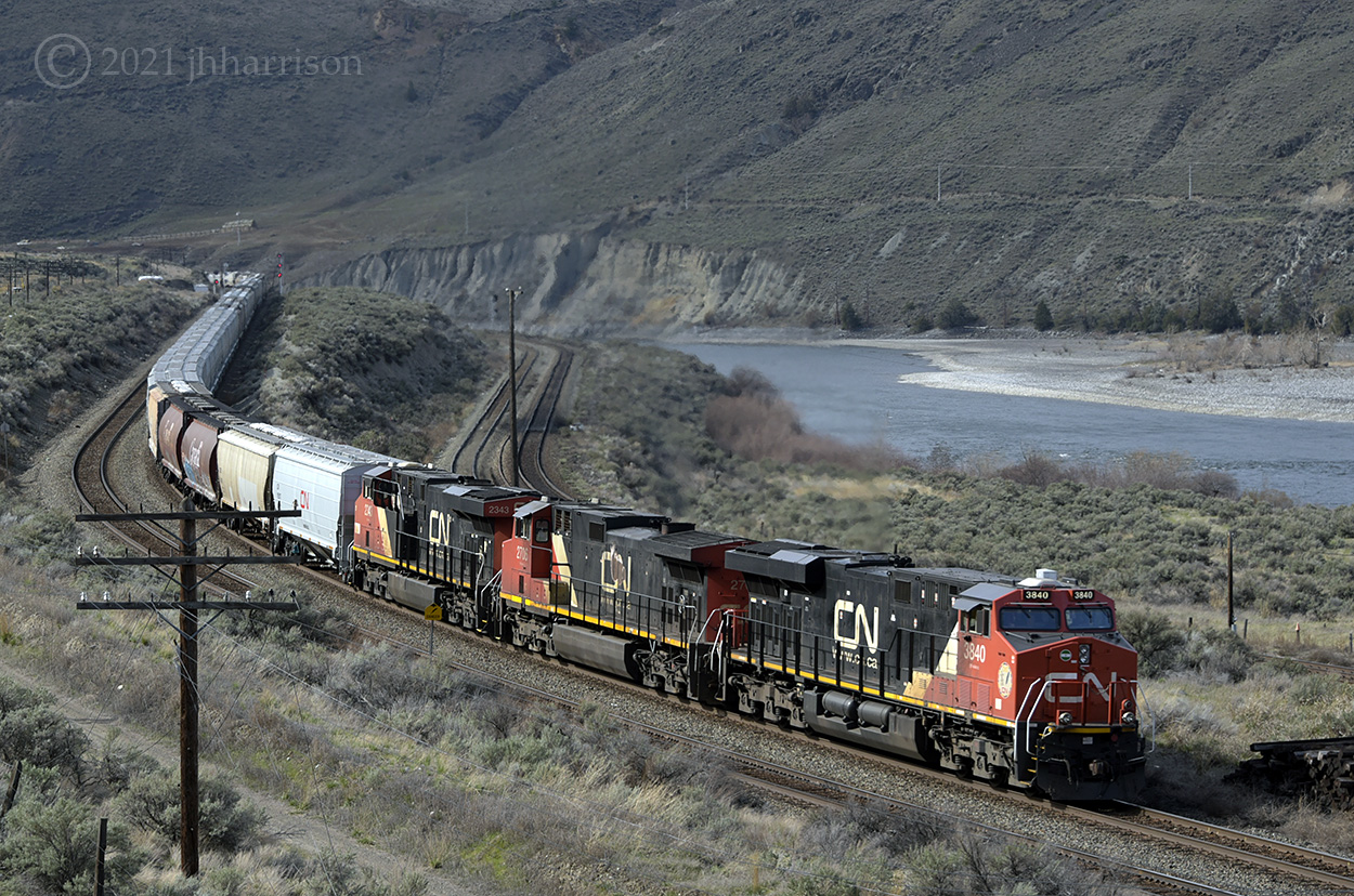 CN 3840 2706 and 2343 are running eastbound along the Thompson River at Basque, on CPs Thompson Sub. In a short distance, the train will connect with CNs Ashcroft Sub, and bypass the town of Ashcroft.