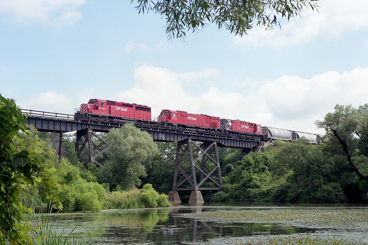 CP power as I used to enjoy it. A continual mixture.  Here, we have CP 5794 (SD40-2), 4742 (M-636) and 4230 (C-424) with train #507, a Toronto to Detroit daily that interchanged with CSX. I noted it was a nice day down by the old "swamp pond", but rather hot and humid.  This really lazy "river" looks so idyllic.