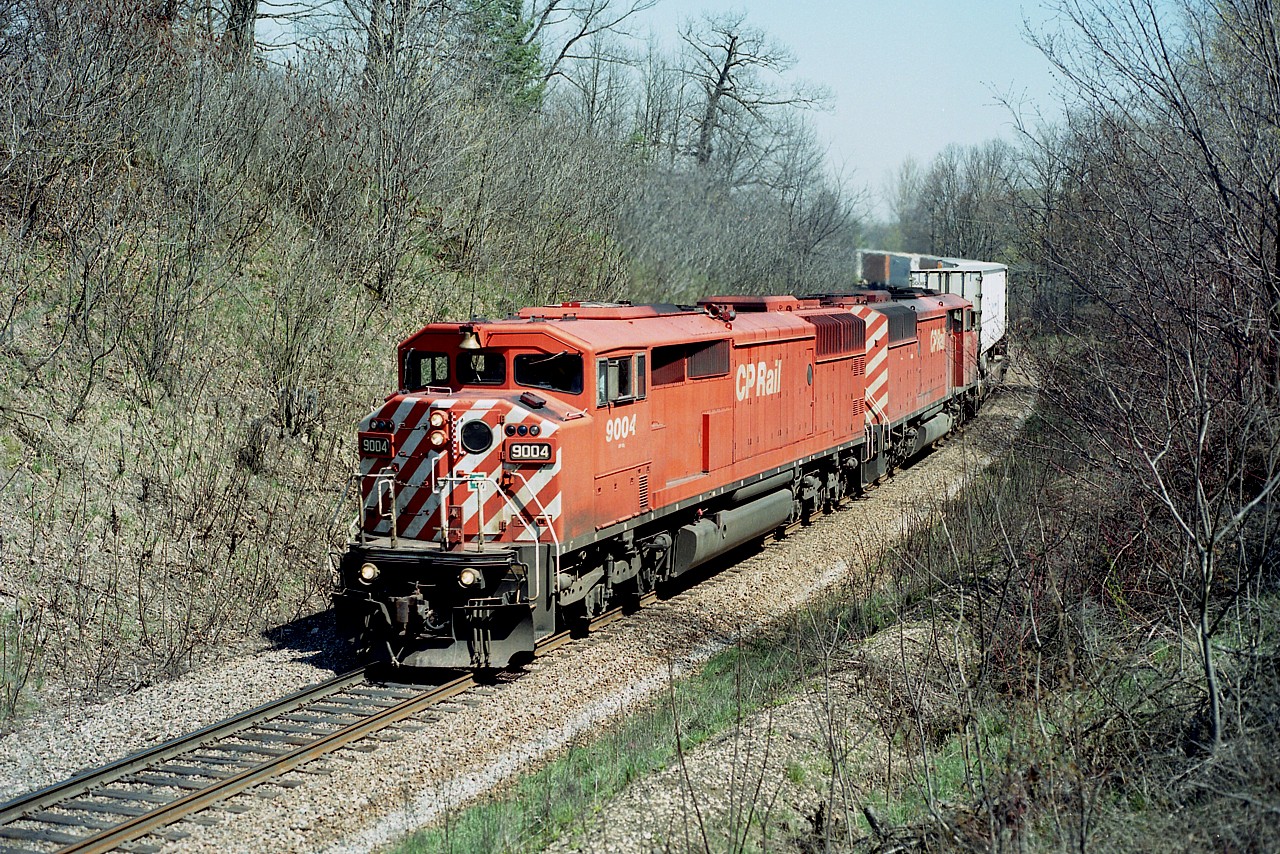 Matched pair of CP Red Barns making their way westward, just around the curve from the Orrs Lake namesign after crossing the Grand River at Cambridge. CP 9004 and 9002, built 1988; have left the roster, as all Barns (9000-9024) have. CP 9004 went to CMQ in 2015 and the 9002 departed for J&L Consulting in 2016.