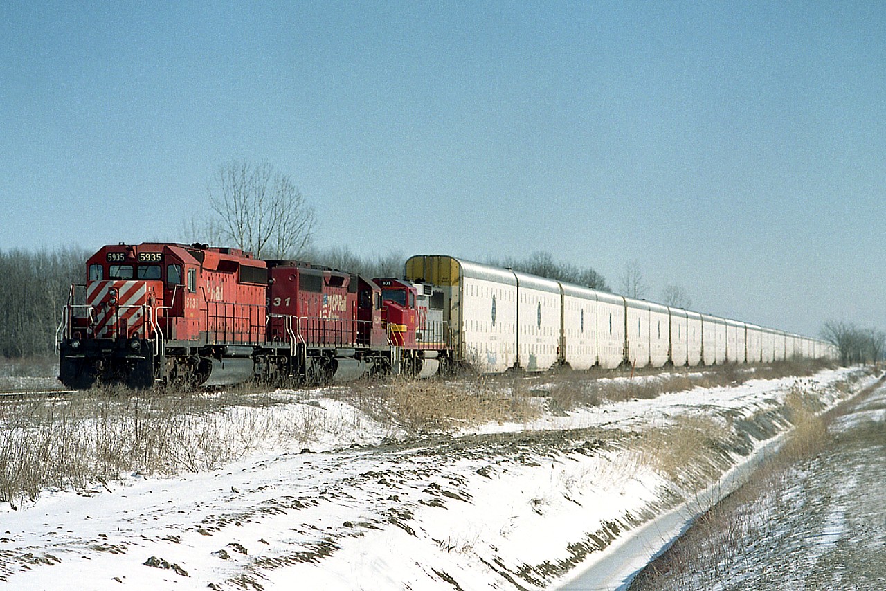 I had wondered about these large Auto-Max cars and apparently they are achieving some success on the BNSF and some other roads in the states.  But I have seen very few of them along the Hamilton Sub in the past few years.
CP 5935, 5631 and a GP60M #101 of the BNSF are powering this train. The #101 is a former ATSF unit, and come to think of it, I don't recall seeing one of these along the line before or since, either. This image is in Welland Yard, as shot from the parallel Lambert Rd.