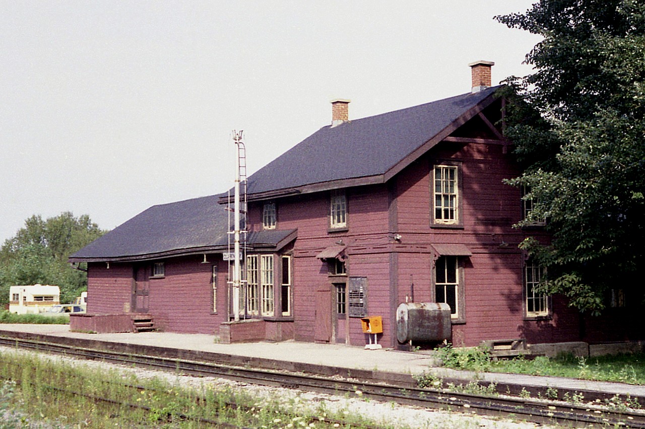 Old time station, now long gone.  Claremont is but an unincorporated region of the municipality of Durham. The village has roughly 1200 people. There is not much there. The general store burned down in 2009.
The Ontario & Quebec RR came thru in 1884. This was just another "paper road" part of the CPR. The station, built back then, survived until a couple of months after this photo, when it was torn down due to high costs of heating and upkeep. CP was doing a real demo of stations along the line back then.
Large drafty building. Note the oil tank. The Globe and Mail newspaper box, probably selling papers at 15c ea then, is on the honour system. And the "train times" board lists the arrival times of the CP Dayliners, which ran until the big VIA cuts of 1990.
The station was on Track Street, south side off old Brock Road.  Nary a trace of it now. After all, it has been 43 years.