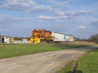 GEXR 583 is seen trundling northbound from Guelph Junction with traffic for PDI and a car for Owens Corning Fiberglass third up passing through the hamlet of Corwhin at 1816h.<br><br>While Corwhin developed largely around the Guelph Junction Railway, its early years took place about 1 kilometer east of the rail line at the intersection of Wellington Road 34 and Nassagaweya-Puslinch Townline, right on the Puslinch and Halton border. The mid 1800s saw numerous settlers come to the area and the settlement of Corwhin was one of many nearby. It consisted of a church, blacksmith shop, and post office, though the village had never prospered as the only route to town involved a poorly built swampy road. The building of the GJR in 1887 changed that with reliable transportation to the area, leading to the post office and general store being moved closer to the railway. Under CPR operations the railway built a small station <a href=http://www.trainweb.org/oldtimetrains/CPR_London/stns/corwhin.jpg>(a second being built circa 1911),</a> used by high school students headed to Guelph, in addition to a house for the local section foreman, and a couple of sidings for use by the nearby coal yard and stock pens.*<br><br>Despite having <a href=https://open.library.ubc.ca/collections/chung/chungtext/items/1.0362209#p7z-3r0f:>a number of trips each day,</a> Saturday, August 4, 1962 saw the end of passenger service on the GJR and as the station was no longer needed it was moved to a farm owned by Ontario's Provincial Secretary, John Yaremko. For a number of years passenger service was operated using a battery car, <a href=http://www.trainweb.org/oldtimetrains/CPR_London/9002a.jpg>often CPR 9002,</a> nicknamed "Old Sparky" by residents along the line. Sparky would be replaced by a gas-electric doodlebug, <a href=http://www.trainweb.org/oldtimetrains/CPR_London/9004a.jpg>usually CPR 9004,</a> in the 1940s until 1958 when <a href=http://www.trainweb.org/oldtimetrains/CPR_London/5405_psgr.jpg>steam powered mixed trains</a> would take over the passenger service for its final years.<br><br>*Information from Puslinch Historical Society