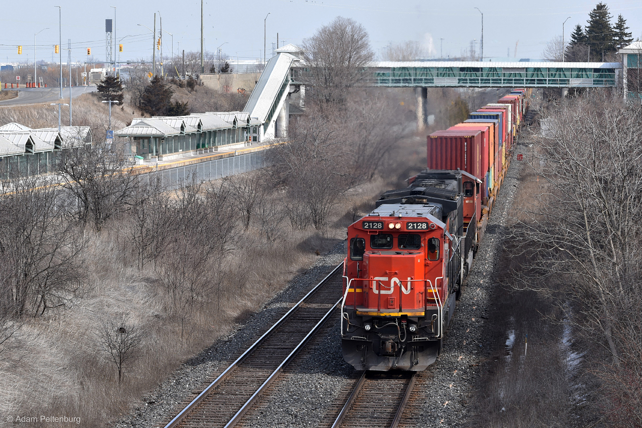 After waiting at Whitby for a VIA train to pass, CN 149 is the first of three halted freight trains to begin moving again. In the lead is 2128, one of the ex-CNW Dash 8s to receive the 15th anniversary logo on the side. Unfortunately, RTC made the last-minute decision to route it on the south track which prevented me from getting it in the shot! Still quite happy with the way this turned out as the sun decided to peek out at the last second.