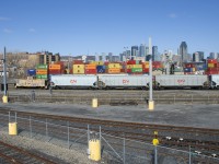 The beat up caboose and the new hoppers at the tail end of the Pointe St-Charles switcher provide quite a difference in appearance as they enter the yard with grain empties.