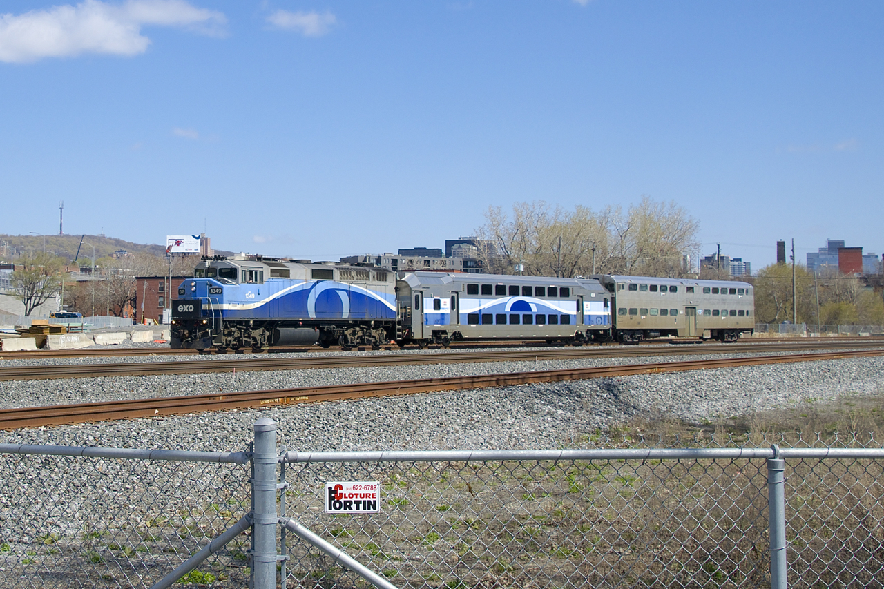 Gallery cab car AMT 900 is on its way from the EXO Pointe St-Charles Maintenance to Exporail as it passes MP 4 of CN's Montreal Sub. This car is being donated to the museum and will get there via CP's Adirondack Sub.