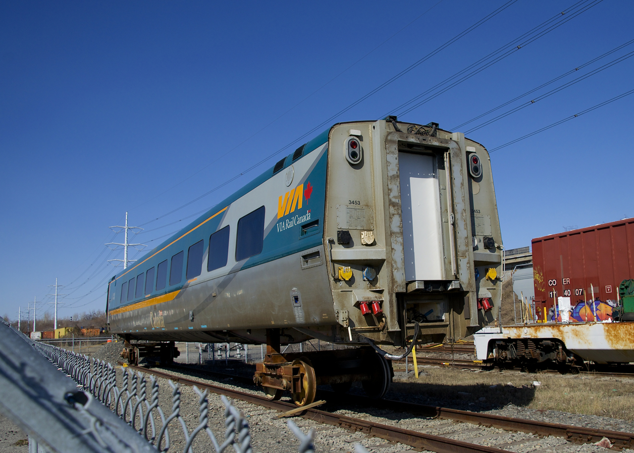 An LRC business class car is on temporary trucks as it sits in the yard at Cad Railway Industries.