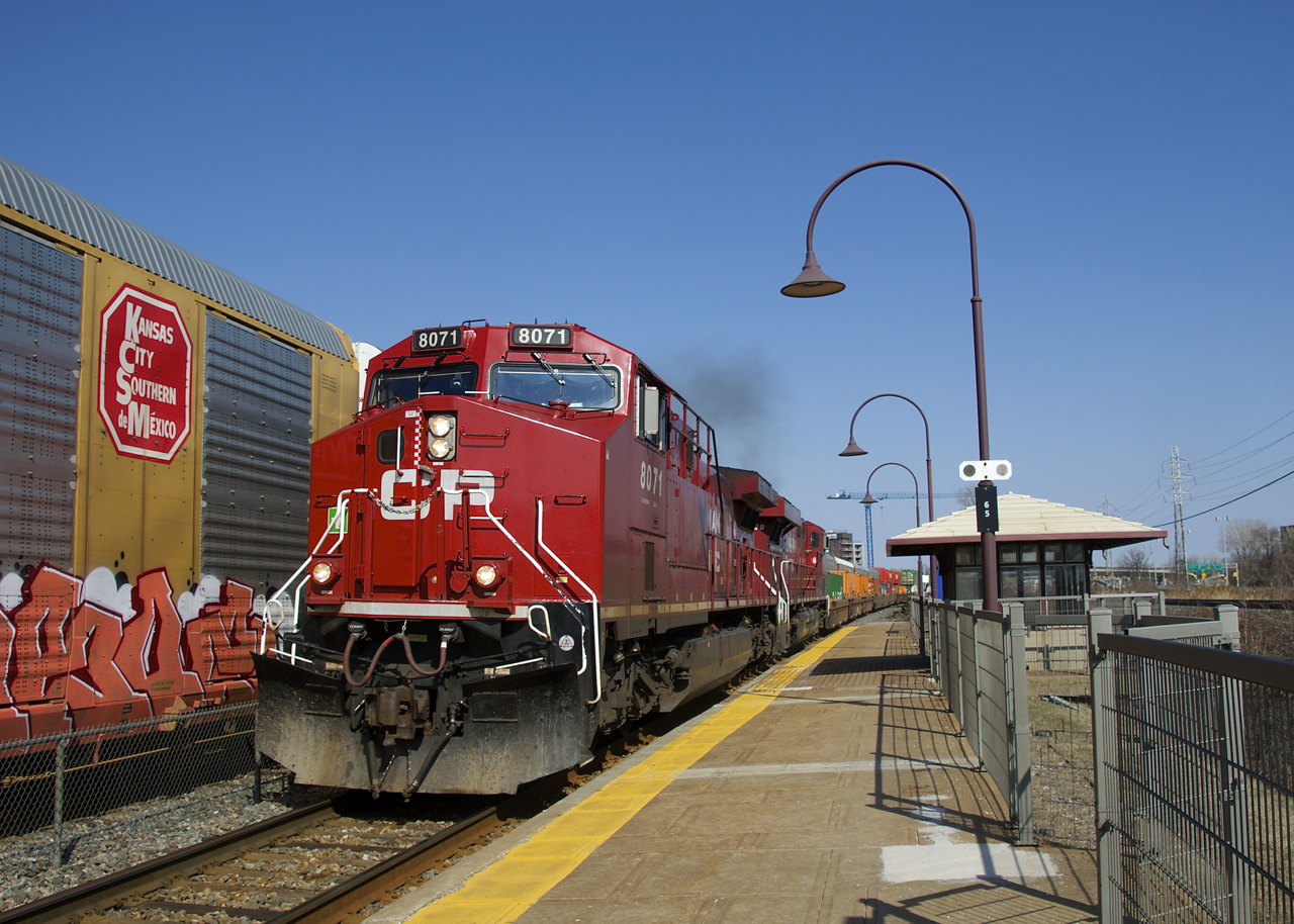 CP 143 with CP 8071 & CP 8899 for power is passing a CP 112 which is held out until CP 143 clears Dorval. A KCS logo on an autorack at left brings to mind the recently proposed CP-KCS merger.