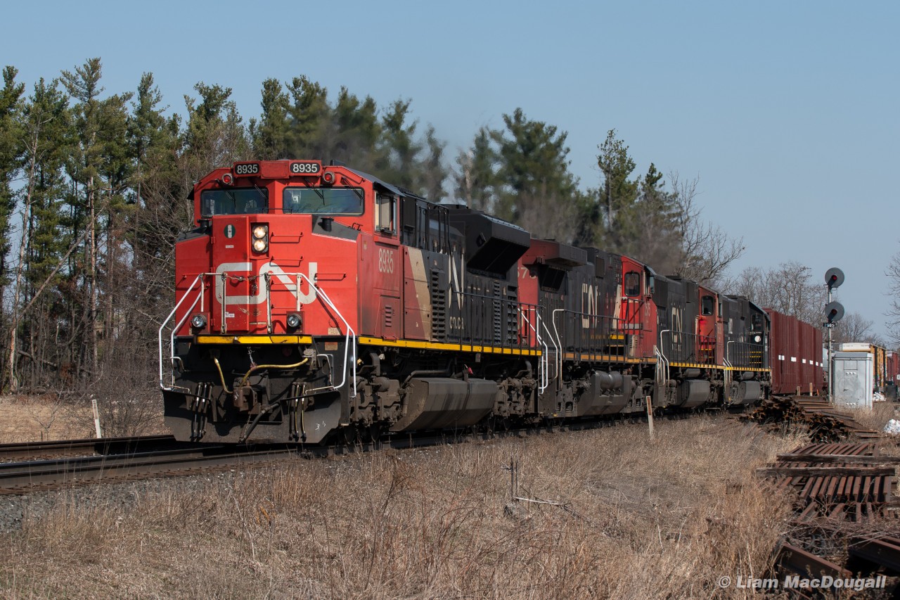 On a sunny April morning, CN 397 works its way through Stewarttown with an SD70M-2 leading and an IC Deathstar fourth out.