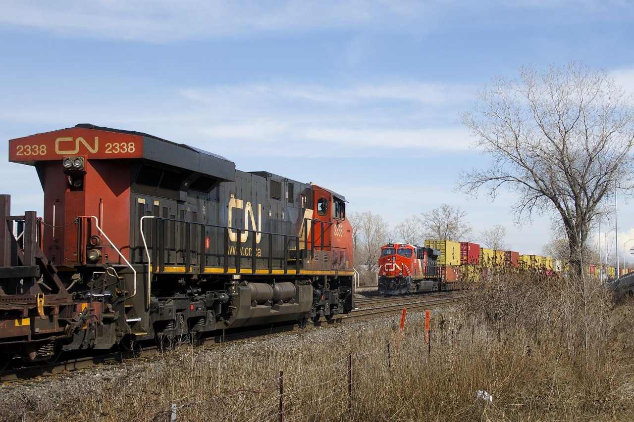 GEVO's meet as CN 368 with CN 2338 leading is about to pass a parked CN 106, with CN 3885 on the tail end.