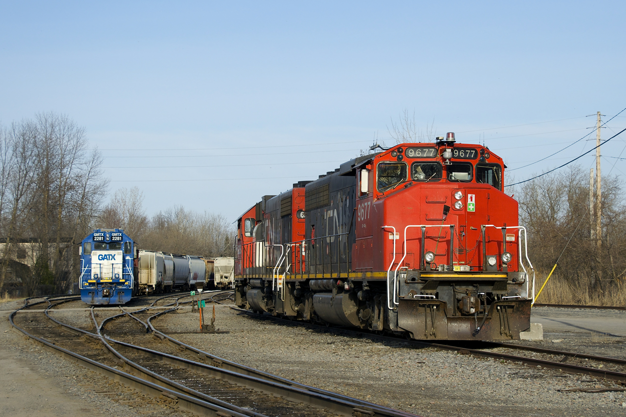 Two sets of local power rest behind the Coteau Station in the evening. At left is GMTX 2281, with CN 4721 out of sight behind it. At right are CN 9677 & GTW 6226.