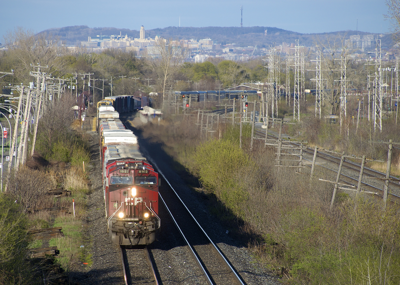 CP 119 heads west with Mount Royal looming in the background. Power is CP 8902 and CP 8156 up front and CP 8200 mid-train.