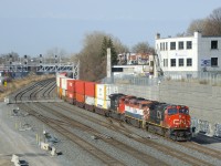 It looks like an intermodal train is rounding a curve, but it's actually grain train CN 878 with some intermodal traffic up front. After dropping off a small bit of grain cars on track 29, it will continue to the Port of Montreal. Power is CN 2656, BCOL 4609 & CN 8872.