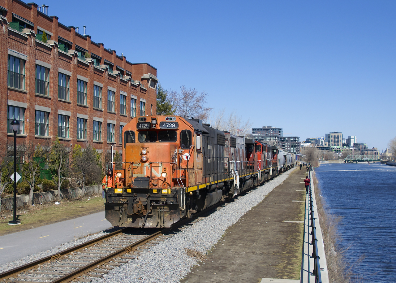 After picking up grain empties at Ardent Mills, the Pointe St-Charles Switcher is heading back to the main line with CN 4729, CN 4774, CN 9576 & CN 9523 for power. At right is the Lachine Canal and at left is a building that was once a Stelco factory.