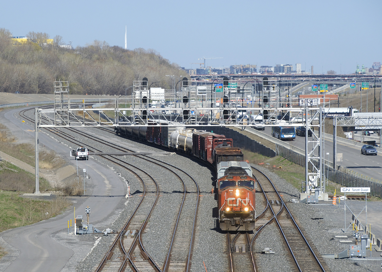 CN 5628 is all the power needed as a short CN 323 passes Turcot Ouest with 21 cars received in interchange from the NECR in St. Albans, Vermont.