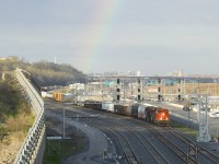 A rainbow is above as CN 321 approaches Turcot Ouest with CN 8873 and CN 2339 for power.