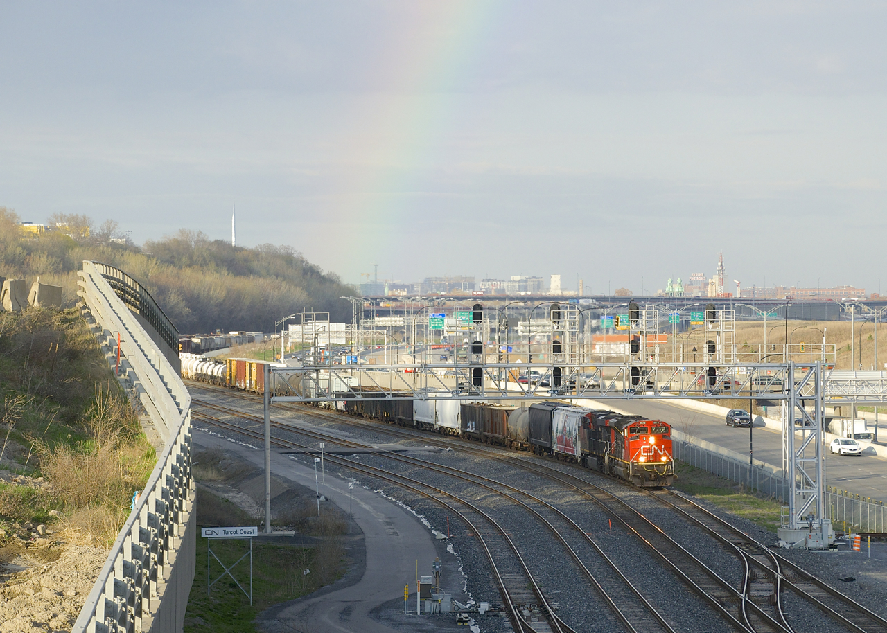 A rainbow is above as CN 321 approaches Turcot Ouest with CN 8873 and CN 2339 for power.